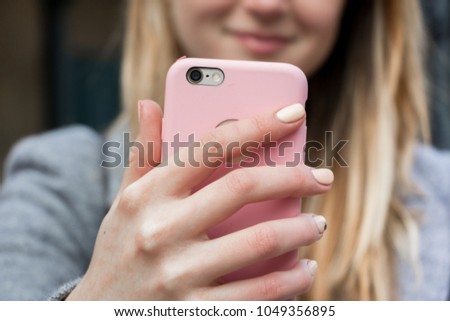 Blonde with pink phone

