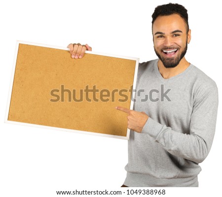 Portrait of a happy afro american man holding blank board isolated on a white background