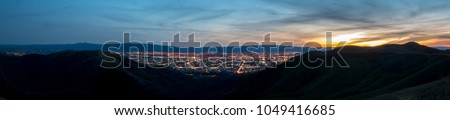 Panorama of Silicon Valley at Night with Lights on and Sunset on the distance