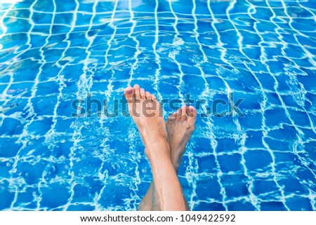Beautiful woman legs in swimming pool.