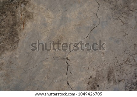 Line of old grey concrete surface cracking on the floor