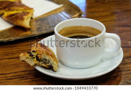 Cup of coffee with croissants on the table in Paris