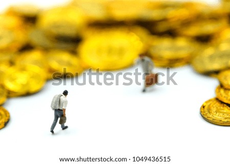 Miniature people : Businessman stand with gold coins.