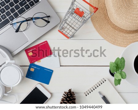 top view online shopping concept with laptop, credit card and smartphone on white table wooden background with copy space.
