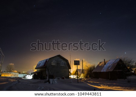 Small houses in winter night under the stars
