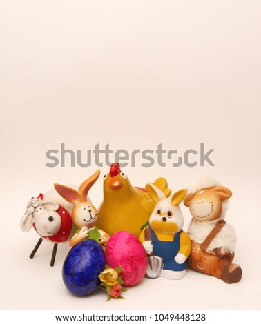 Easter bunnies, sheep, chicken, flowers and colorful eggs in front of a white background.
