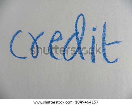 Text credit hand written by blue color oil pastel on paper