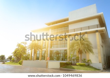 Side view of office building on blue sky background.