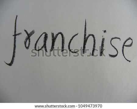 Text franchise hand written by black color oil pastel on paper