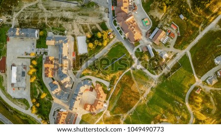 Rosa Khutor plateau, buildings, slopes and chair lifts. Aerial view at sunset  