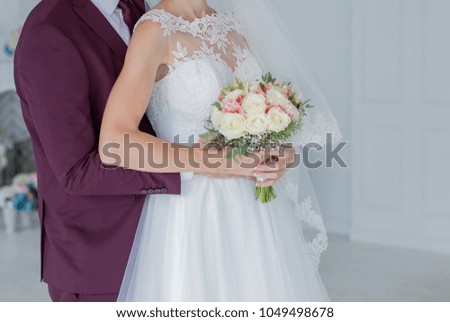 bride with groom in studio with flowers