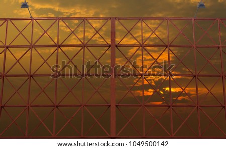 red color steel billboard frame with golden sky