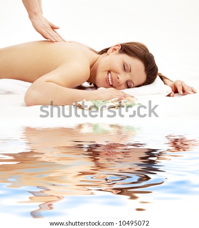 picture of lovely lady taking massage on white sand