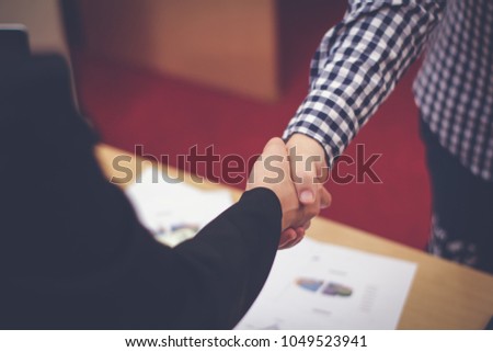 Business people or partnership meeting concept.businessman and woman handshake. Successful after good deal or agreement,blurred background.
