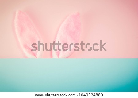 Easter rabbit ears on pink background with copy space, retro toned