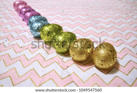 Glitter easter eggs on a chevron background