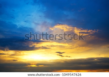 storm clouds at sunset in rays of sun