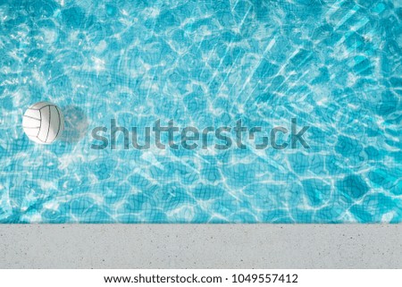 Ball floating in a refreshing blue swimming pool