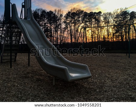 Playground with focus on the slide during sunset at Lake Benson Park in Garner North Carolina, Raleigh Triangle area, Wake County.