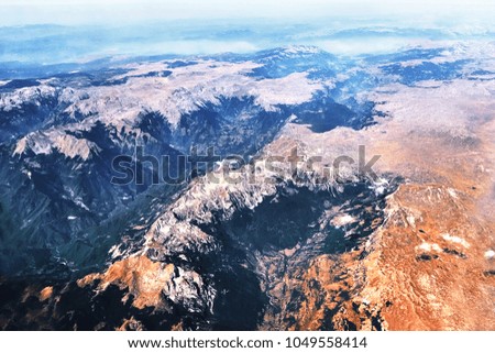 View from airplane on Earth surface. Aerial landscape of green mountains with rivers. Photography of beautiful balkan mountain. 