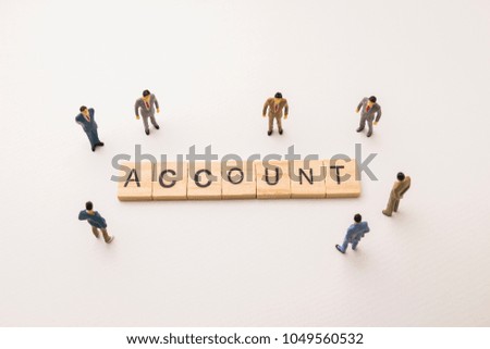 Miniature figures businessman : meeting on account letters by wooden block word on white paper background, in concept of business and corporation