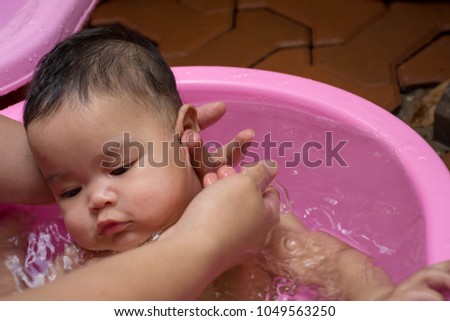 Baby bath in a pink tub
