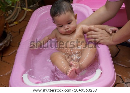 Baby bath in a pink tub
