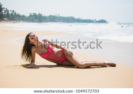 The girl is resting on the Indian Ocean beach in Sri Lanka