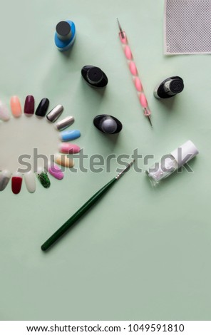 Accessories for nails. Probe for nails. Manicure salon. Work for beauty. Top view. Flat lay. Green background. Nails varnish.