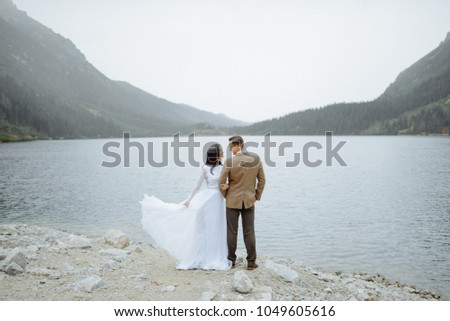 Loving couple on the background of the Sea-eye lake in Poland