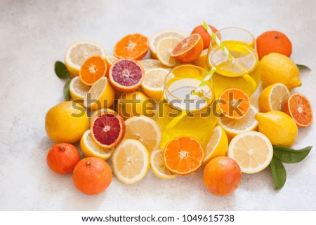 Detox citrus water, refreshing summer homemade lemonade cocktail with lemon, mandarin and orange from above