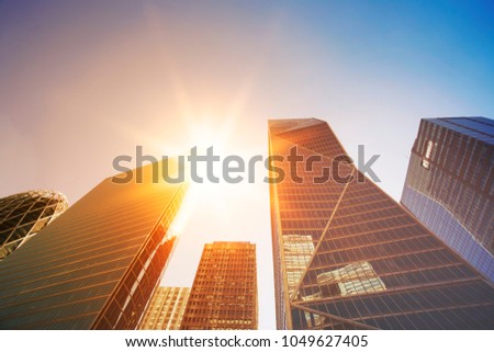 Skyscrapers in Paris business district La Defense. Cityscape with glass facades of modern buildings on a sunny day. Urban architecture and contemporary city life. Economy, financial activity concept.