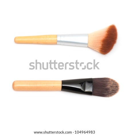 Closeup of women cosmetic brushes on white background