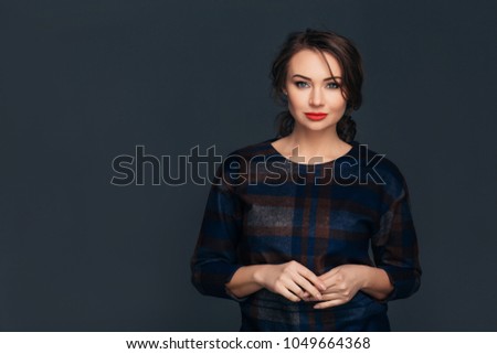 Portrait confident business woman . Confident young stylish woman in business clothes looking at camera while standing against gray background