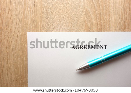 Agreement ready for signing and pen on desk