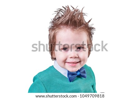 Handsome little boy, in blue bow tie and green sweater, smiling, isolated on white background