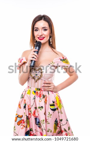 Reporter. Newscaster. Presenter. Young woman in dress holding in hands microphone. Royalty-Free Stock Photo #1049721680