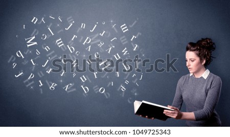 Casual young woman holding book with white letters flying out of it