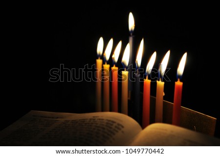 Low key Image of jewish holiday Hanukkah background with menorah and burning candles