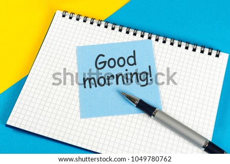 Piece of paper with text Good morning on the yellow-blue table close-up