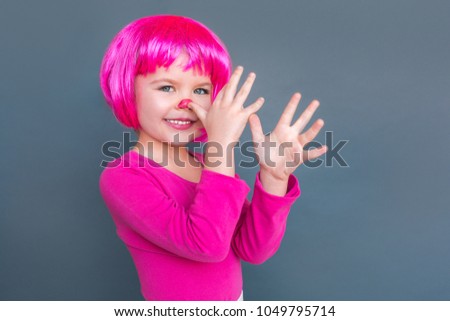 Girl in pink suit in a wig is fooled at camera