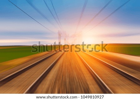 Railroad in motion at sunset. Motion blurred concept image.