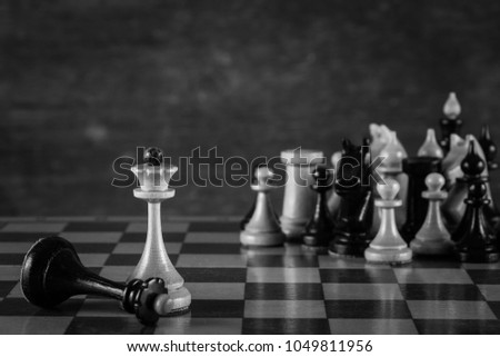 The winner is the white king and the defeated black king on the chessboard. Chess. Competition and victory concept. 
 Black and white photography