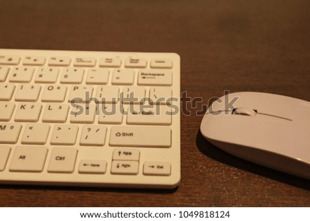 white wireless mouse and keyboard on the desk