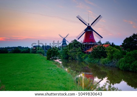 Famous windmills of Greetsiel/Germany at sunset Royalty-Free Stock Photo #1049830643