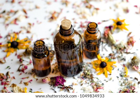 Dried Flowers Essential Oil Amber bottles on white backgrounds