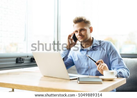 Stylish young man calling by the phone to solve business problems. Online consultation by phone. Freelancer discussing the development and planning of his online project. Outsourcing. Mobile services. Royalty-Free Stock Photo #1049889314