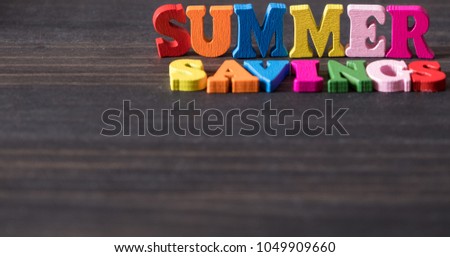 Conceptual images of SUMMER SAVINGS text on wooden background.