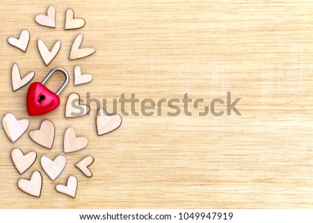 Top view shot of red heart lock on wood heart background with copy space