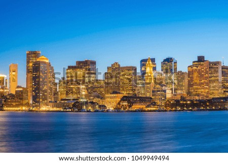 Panorama view of Boston skyline with skyscrapers over water at twilight in United States
